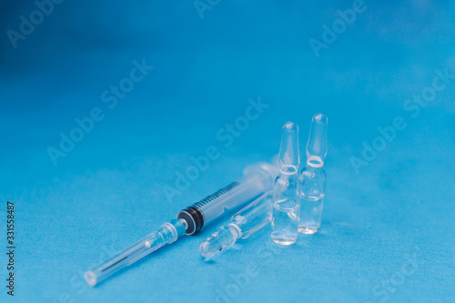 Vials to syringes at a hospital table, Hepatitis vaccine in clear vial. Immunization and treatment COVID 19 or corona virus infection(novel corona virus )from Wuhan. Pandemic and vaccination concept
