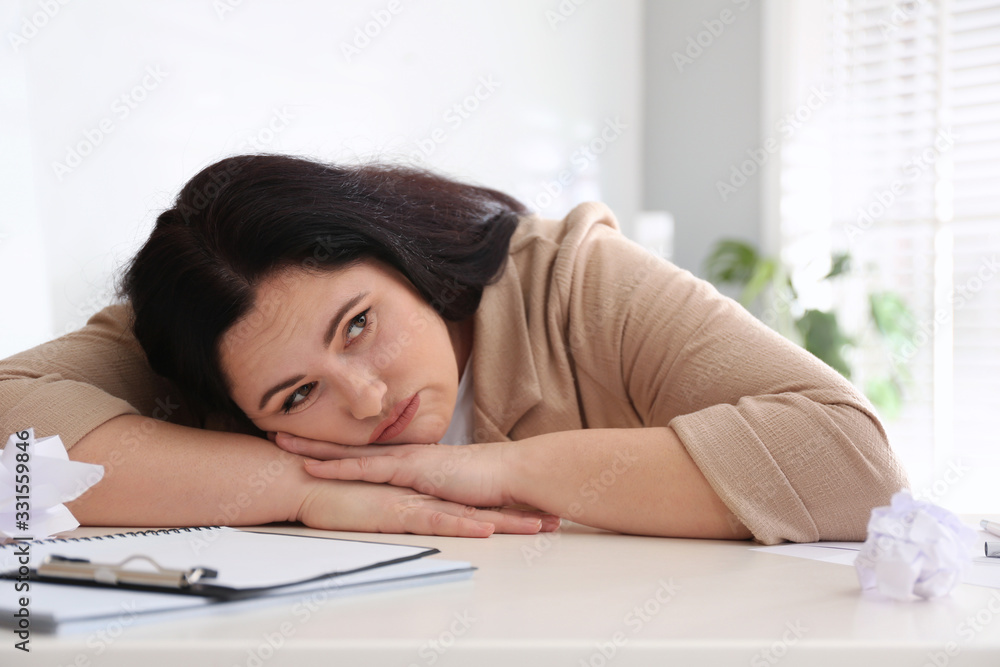 Lazy overweight worker at white desk in office Lazy overweight worker at white desk in office