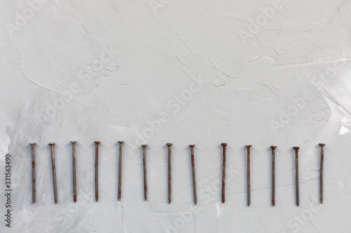 Old rusty nails on gray background  carpentry concept  copy space