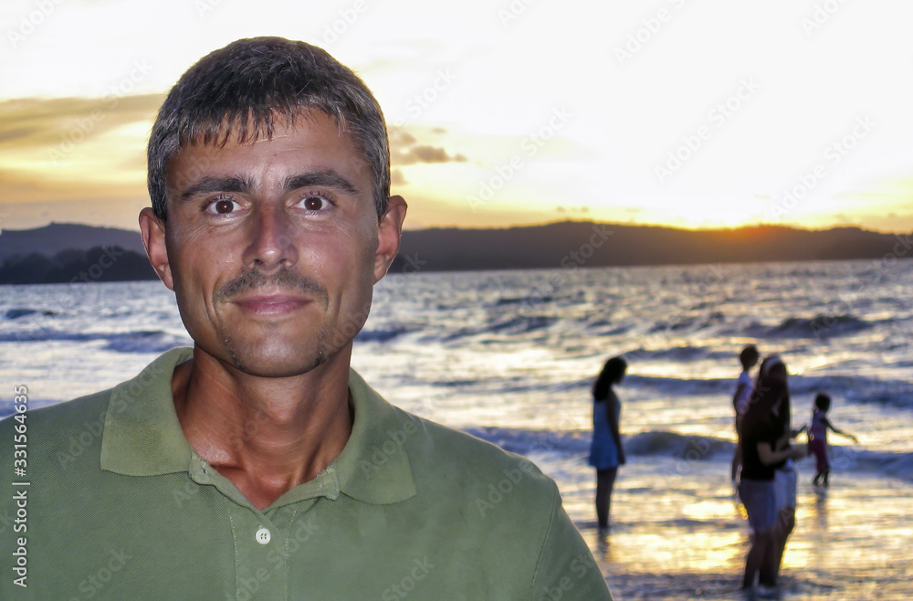 Happy man enjoying beautiful sunset on the beach Happy man enjoying beautiful sunset on the beach