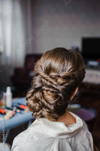 Beauty wedding hairstyle. Bride. Brunette girl with curly hair styling with barrette. Attractive young brunette woman with beautiful hairstyle with hair detail accessory