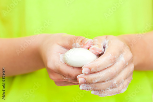 Front view on womans hands with soap foam
