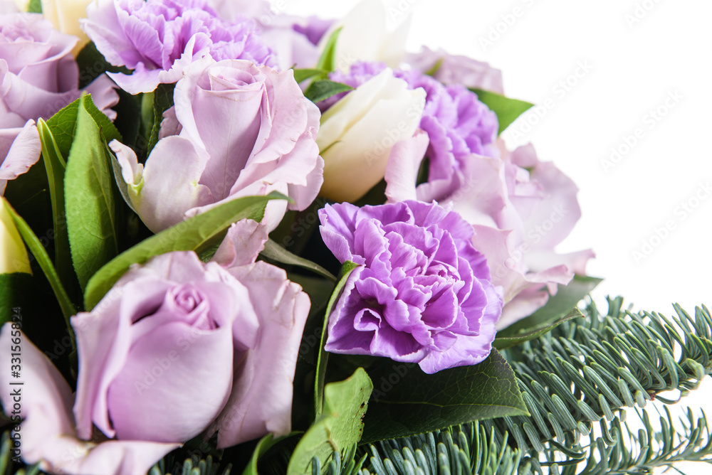 Obraz premium Fresh, lush bouquet of colorful flowers for present isolated on white background. Wedding winter bouquet of purple and white roses and freesia flowers. Christmas bouquet
