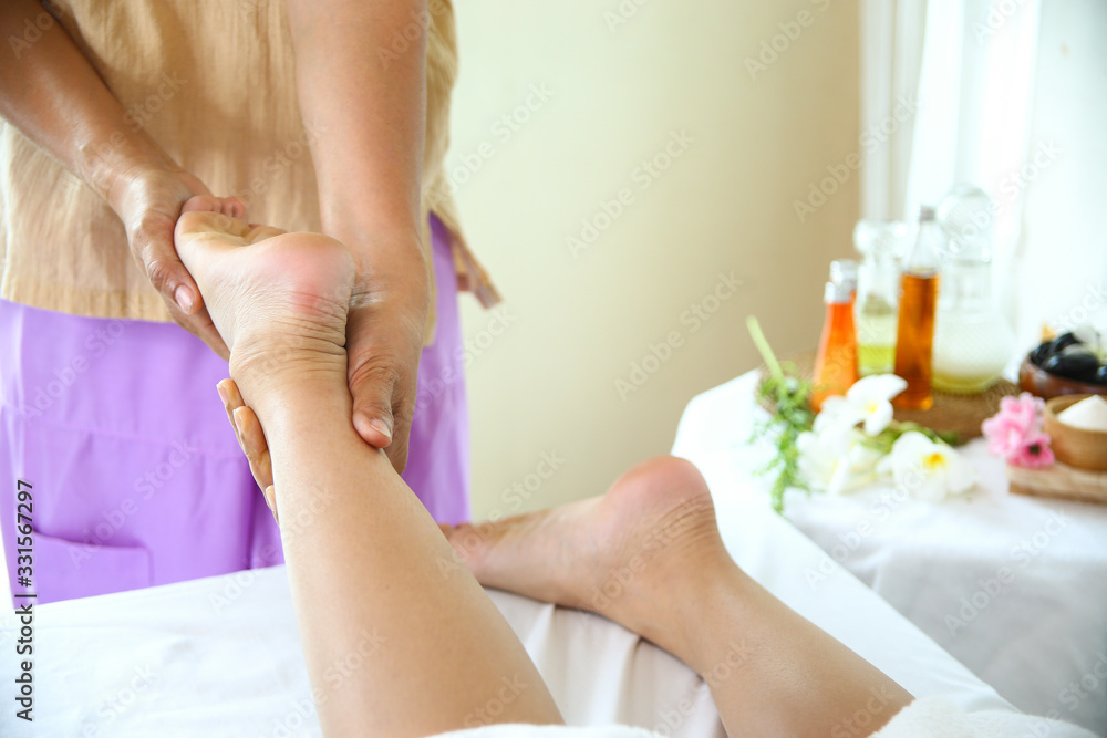 Masseuse use two hand to foot massage with young female Masseuse use two hand to foot massage with young female