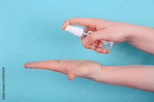 Womans hands using antibacterial hand sanitizer, closeup