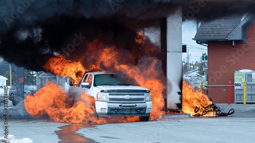 Pickup truck and snowmobile on fire at gas station