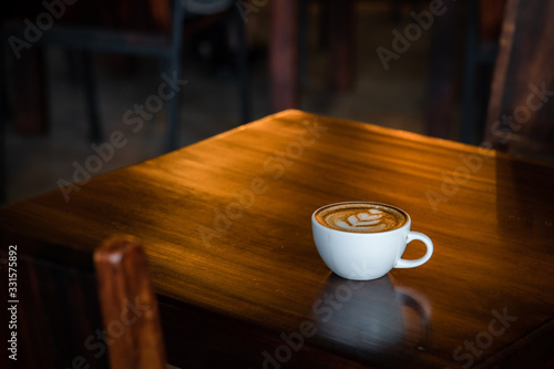 Hot coffee cup on a wooden table.