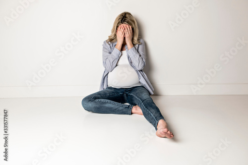 Pregnant woman with a lot of stress on white background