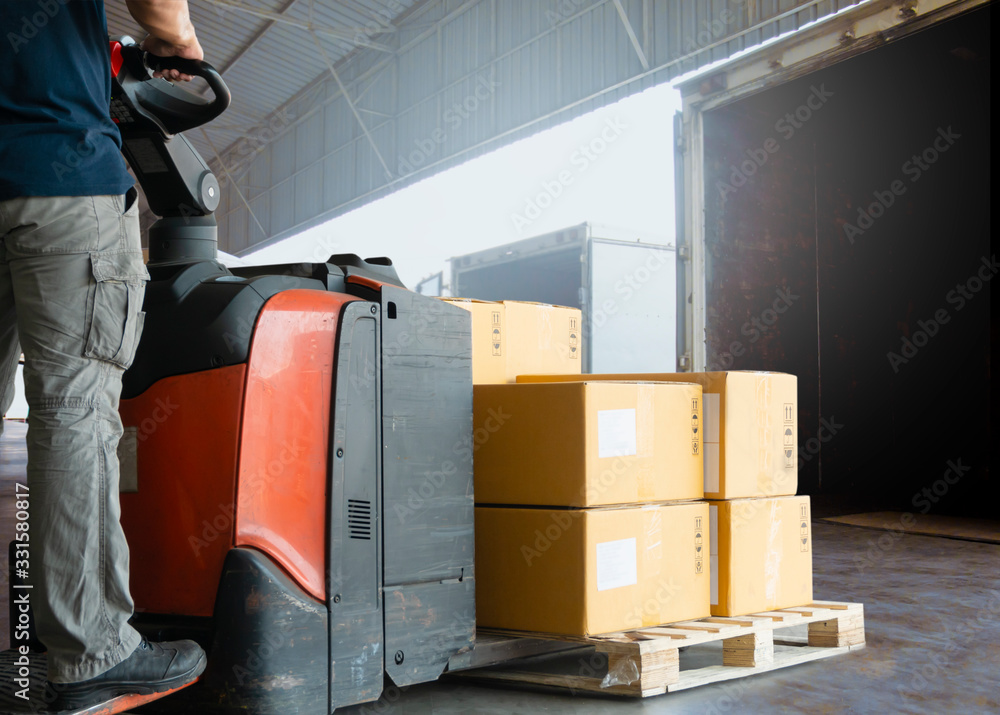 Forklift driver loading pallet shipment goods into a truck, Road ...