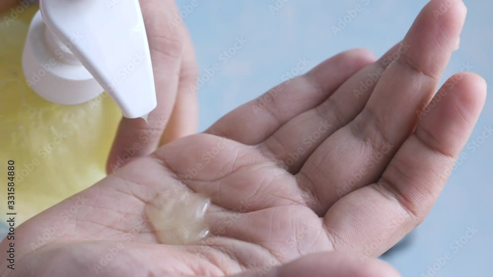 Female hands using hand sanitizer, close up Female hands using hand sanitizer, close up