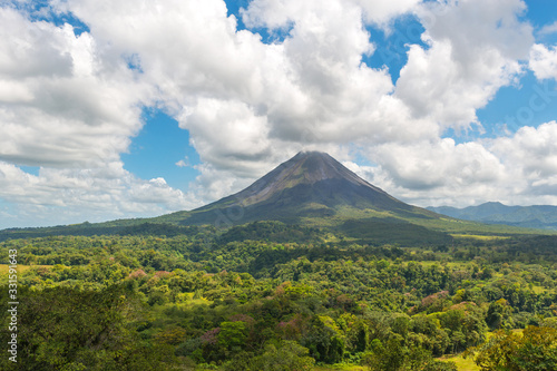 The majestic Arenal volcano surrounded by tropical rainforest on a warm summer day near La Fortuna, Costa Rica, Central America.