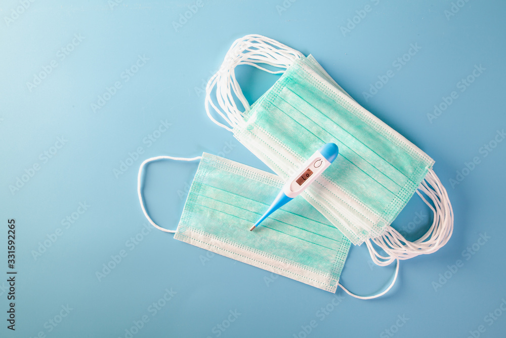 Mask with rubber ear straps. Typical 3-ply surgical mask to cover the mouth and nose. Procedure mask from bacteria. Protection concept. Mask with rubber ear straps. Typical 3-ply surgical mask to cover the mouth and nose. Procedure mask from bacteria. Protection concept.