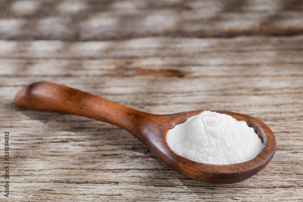 Baking soda on wooden background, space for text Baking soda on wooden background, space for text