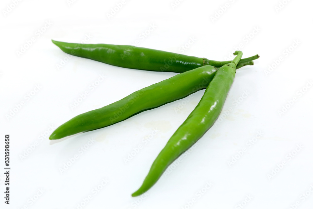 bunch of fresh green chili peppers on a white background bunch of fresh green chili peppers on a white background