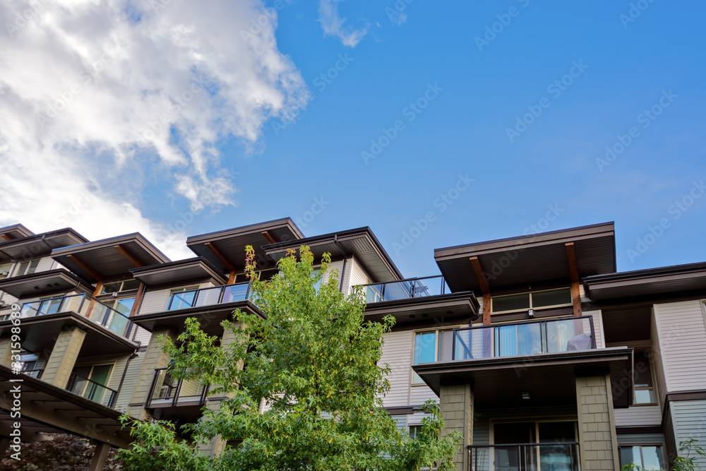 Raising roofs of residential building on blue sky backdrop Raising roofs of residential building on blue sky backdrop
