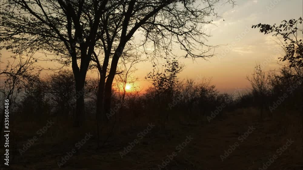 Sun setting in arid African landscape. (4K) Sun setting in arid African landscape. (4K)