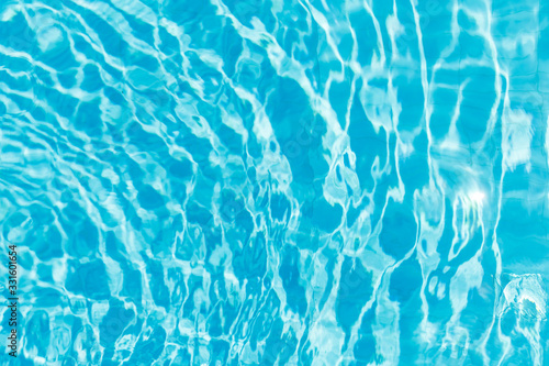 Surface of blue shining swimming pool water ripple. Perfect as a background for summer, vacation, calmness, serenity or any other idea.