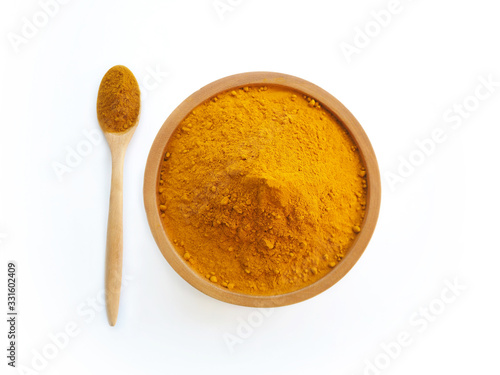turmeric powder or curcuma longa in wood bowl with spoon use as ingredients cosmetics products and is a anti inflammatory compound, antioxidant, including is a herb use for health care.