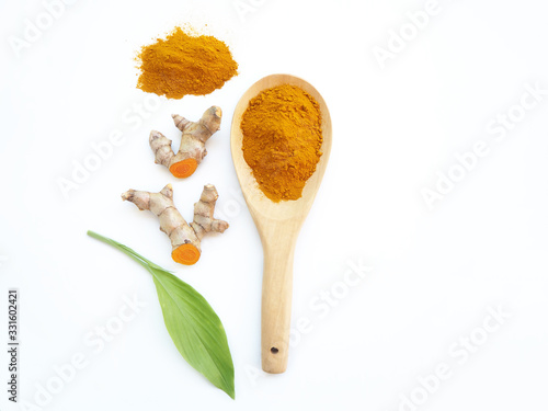 turmeric powder and turmeric rhizome wit spatular or curcuma longa with leaf and use as ingredients cosmetics products and is a anti inflammatory and antioxidant, including is a herb photo