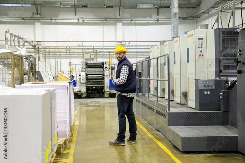 Photography Confident printing worker standing at factory