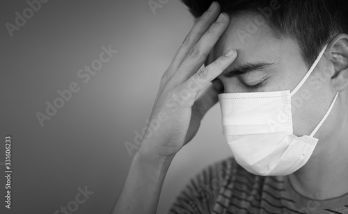 Portrait of stressed man wearing protective face mask. Coronavirus, fear, health concept.