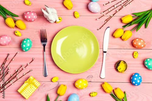 Wall Mural Table setting with cutlery and easter decorations on pink wooden table