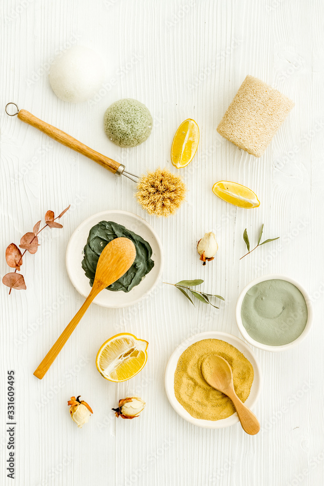 Clay mask, natural facial cosmetic set with herbals on white background - top view Clay mask, natural facial cosmetic set with herbals on white background - top view