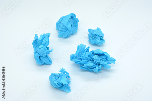 crumpled blue paper isolated on white background, snowball concept, creative crisis, business crisis