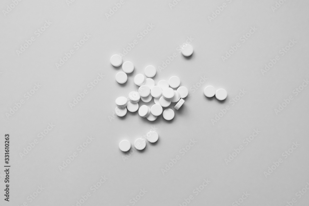 many white pills on a light background