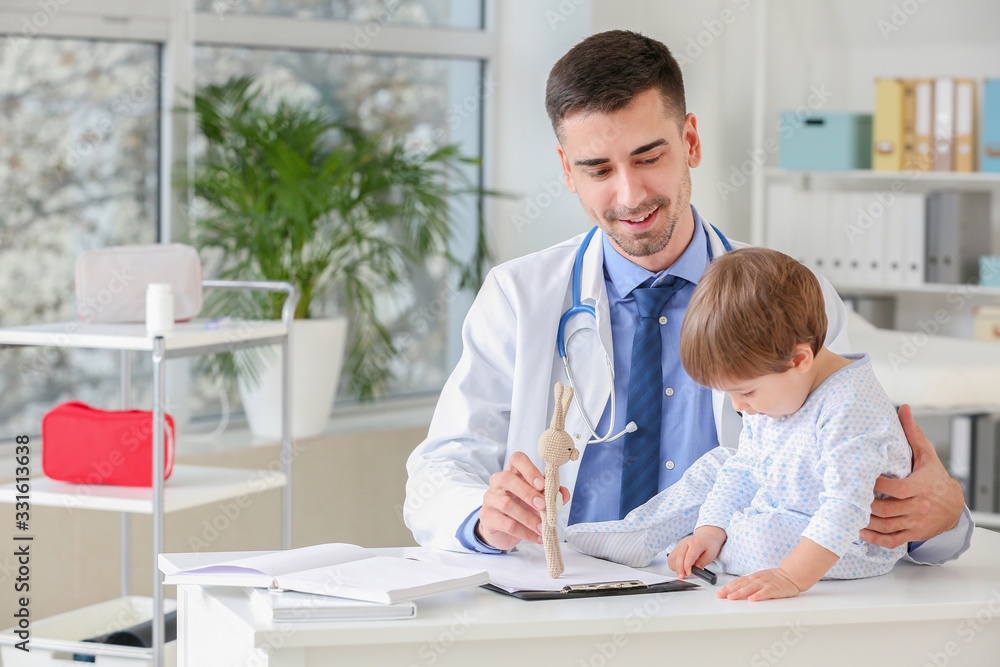 Pediatrician examining little baby in clinic Pediatrician examining little baby in clinic