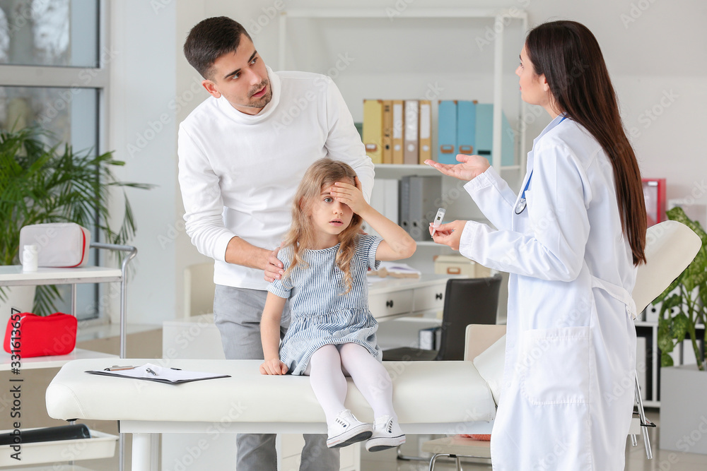 Fototapeta premium Man with little daughter visiting pediatrician in clinic