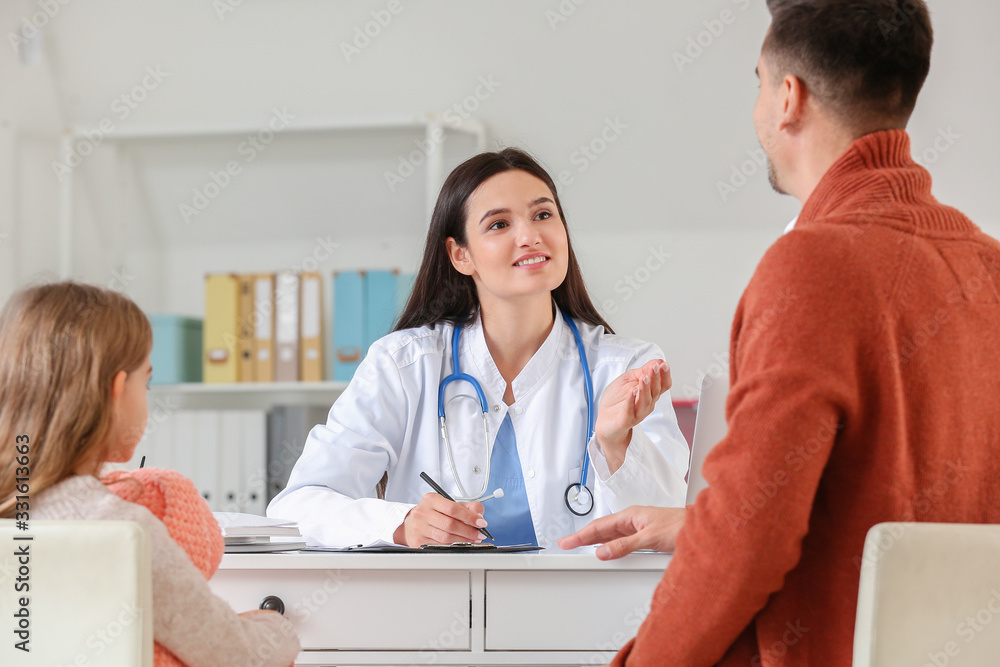 Fototapeta premium Man with little daughter visiting pediatrician in clinic