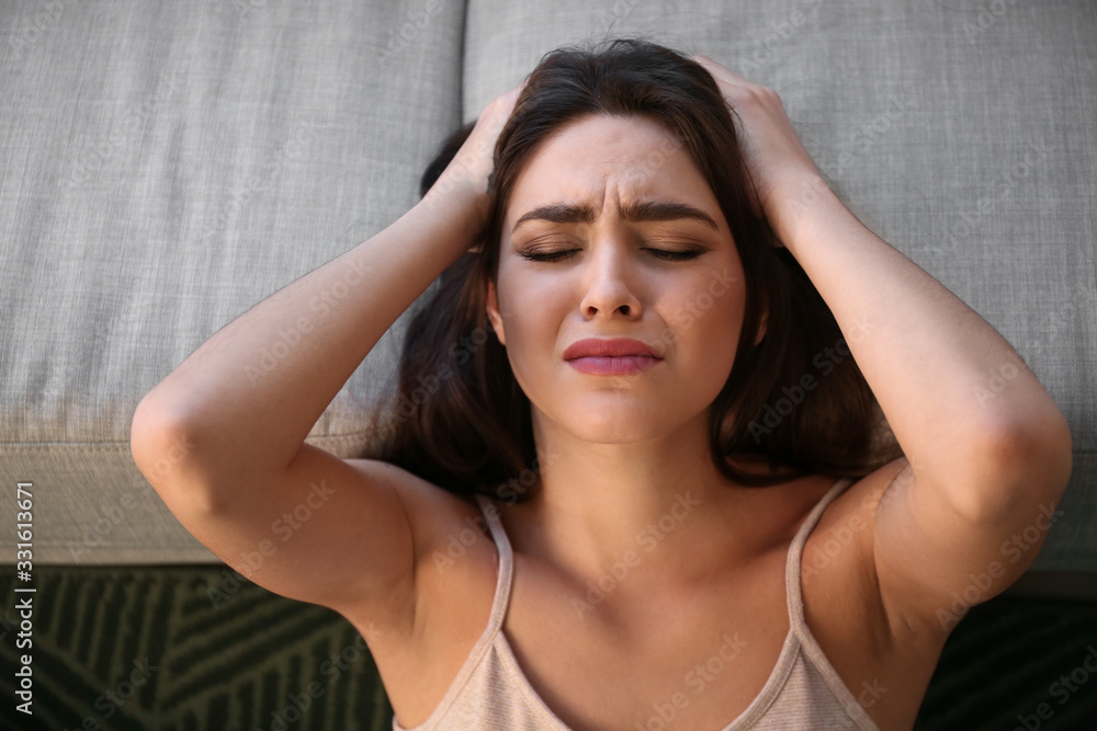 Obraz premium Depressed young woman at home