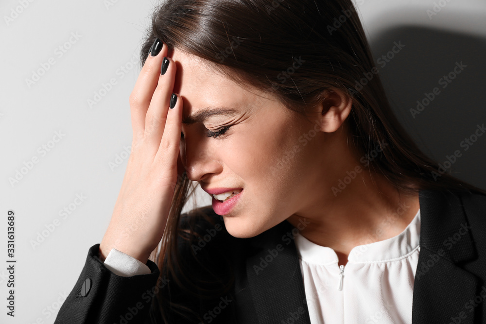 Depressed young businesswoman on light background Depressed young businesswoman on light background