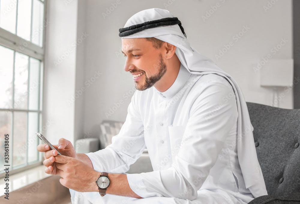Arab man with mobile phone at home Arab man with mobile phone at home