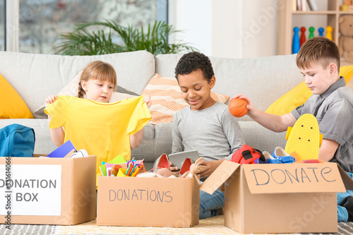 Картината върху платно Little children with donations at orphan home
