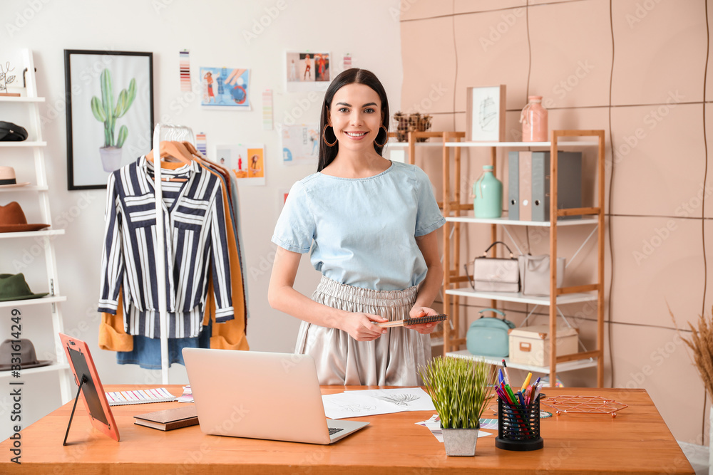 Portrait of female clothes stylist in office Portrait of female clothes stylist in office