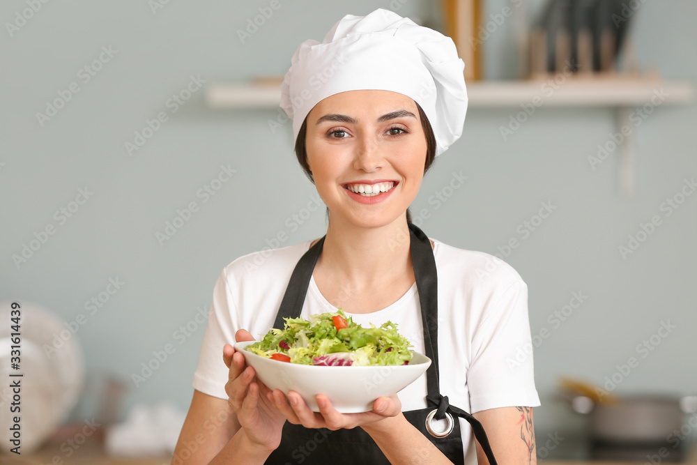 Female chef with tasty salad in kitchen Female chef with tasty salad in kitchen