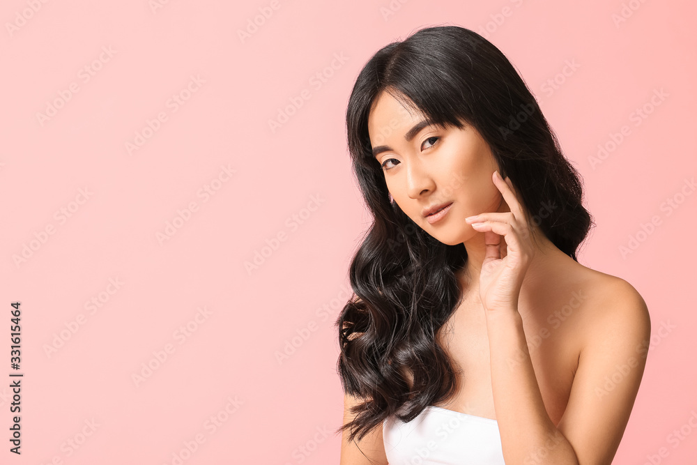Young Asian woman with beautiful long hair on color background Young Asian woman with beautiful long hair on color background
