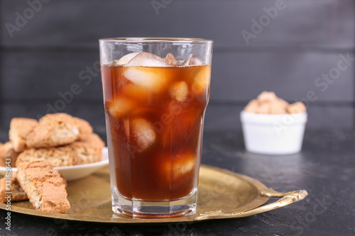 Glass of tasty iced coffee on table