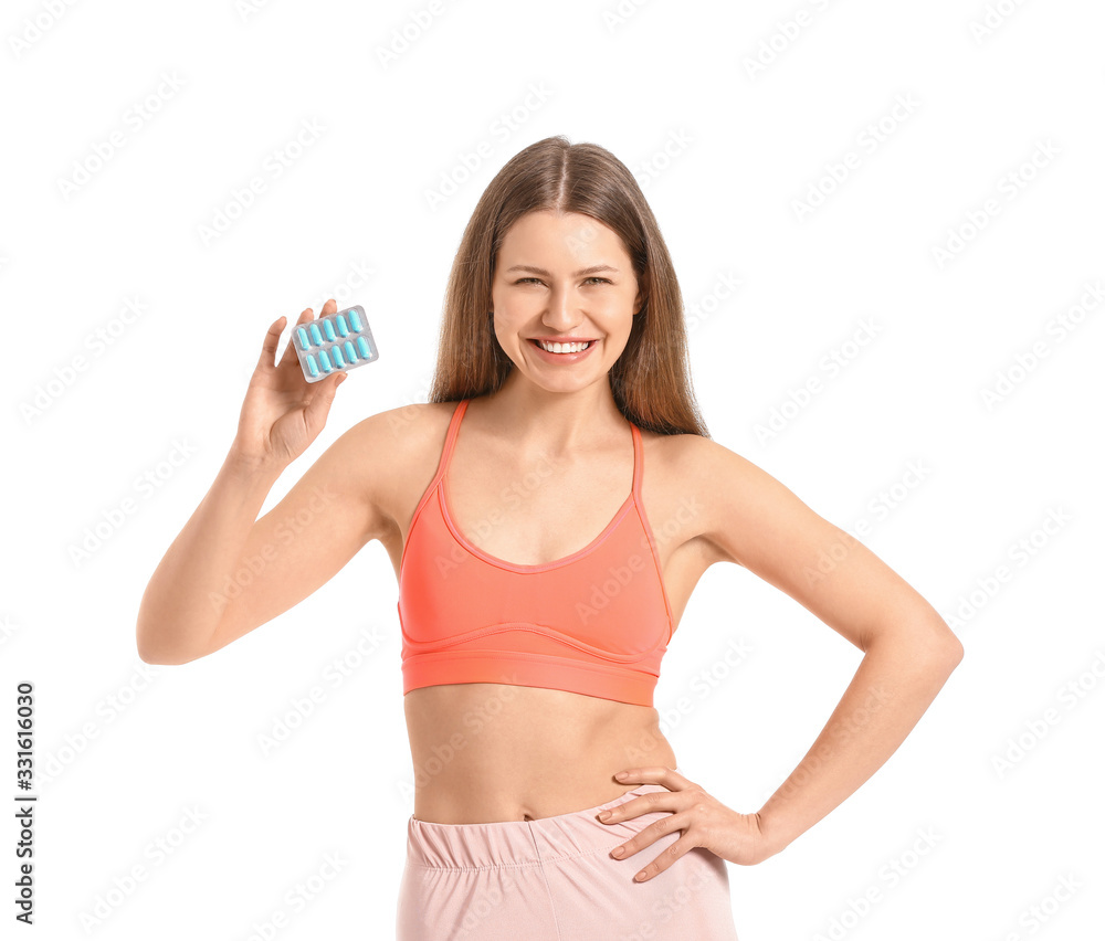Young woman with weight loss pills on white background Young woman with weight loss pills on white background