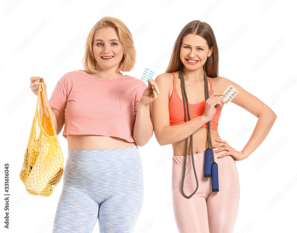 Women with weight loss pills, jumping rope and products on white background Women with weight loss pills, jumping rope and products on white background