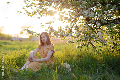 Wallpaper Mural girl on sunset background near a blossoming apple tree Torontodigital.ca