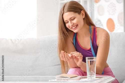 Woman taking weight loss pi...