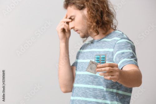 Sad young man with oral ere...