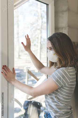 Coronavirus. Young woman staying home in quarantine, looking through the window and wearing protection mask from the illness. Patient isolated to prevent infection of pandemic, epidemic Covid-19 Free Download Coronavirus. Young woman staying home in quarantine, looking through the window and wearing protection mask from the illness. Patient isolated to prevent infection of pandemic, epidemic Covid-19 - GFXLoad