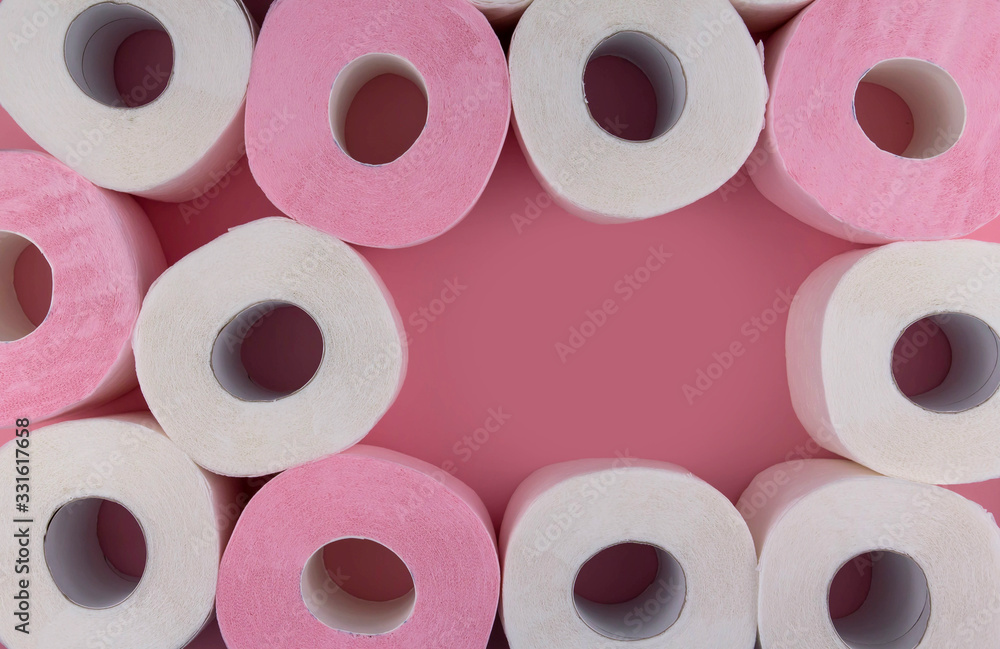 .Rolls of white and pink toilet paper on a pink background copy space. Shortage of toilet paper flat lay. .Rolls of white and pink toilet paper on a pink background copy space. Shortage of toilet paper flat lay.