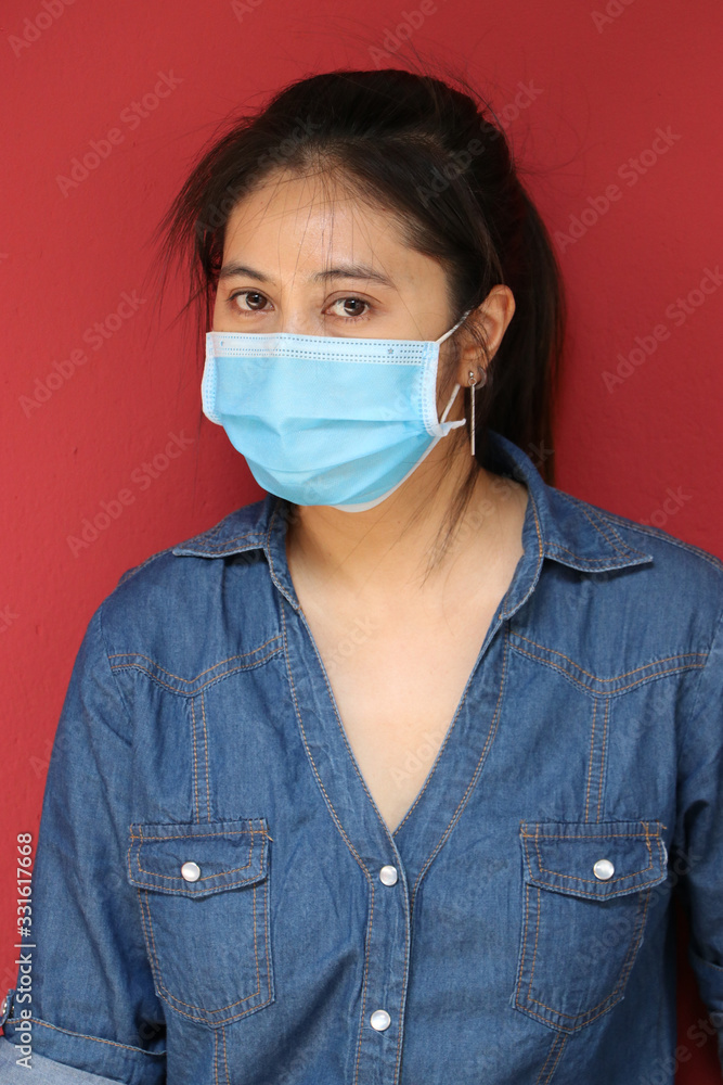 Masked Asian woman prevent germs on red background. Tiny Particle or virus corona or Covid 19 protection. Masked Asian woman prevent germs on red background. Tiny Particle or virus corona or Covid 19 protection.