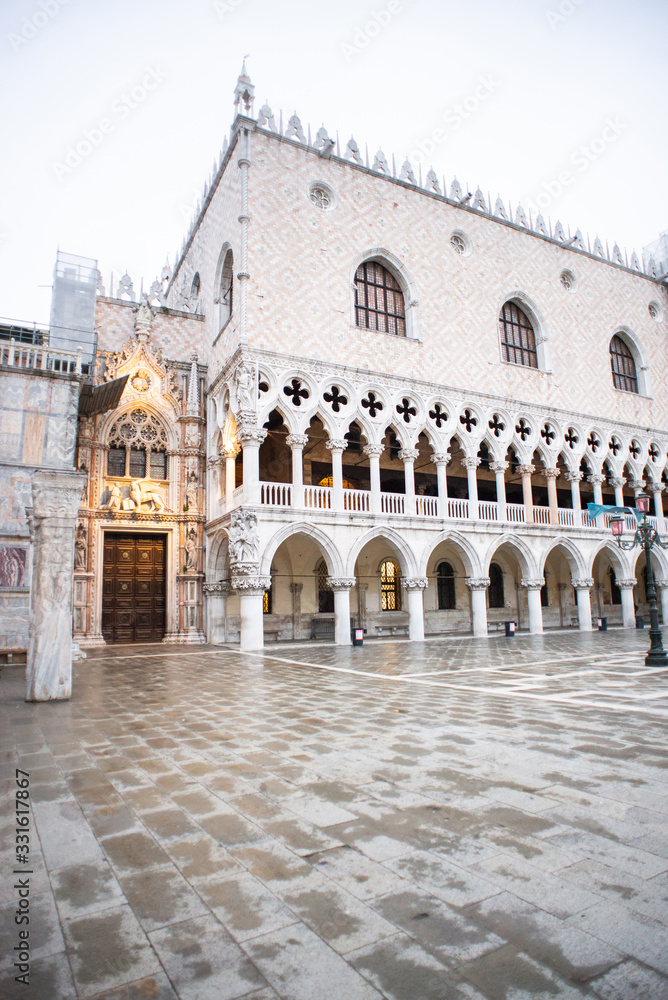 Doges Palace (Palazzo Ducale) and Carta Gate on Saint Mark square at Rainy Morning in Venice, Italy, Europe.
