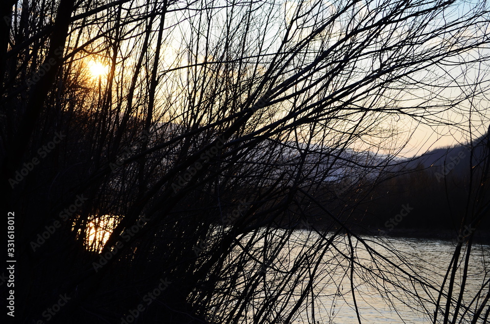 Beautiful river with sunset and trees sky clouds,shadow in the water Beautiful river with sunset and trees sky clouds,shadow in the water